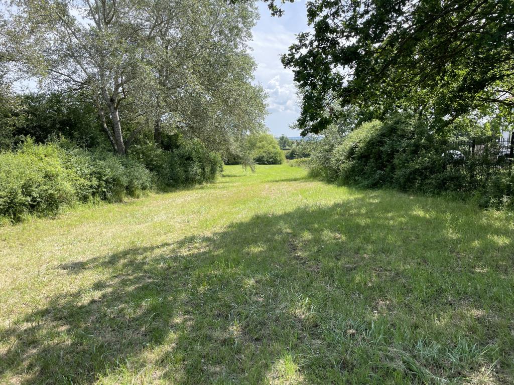 Lot: 46 - JUST OVER AN ACRE OF FREEHOLD LAND WITH POTENTIAL FOR VARIETY OF USES - External view from gate overlooking land
